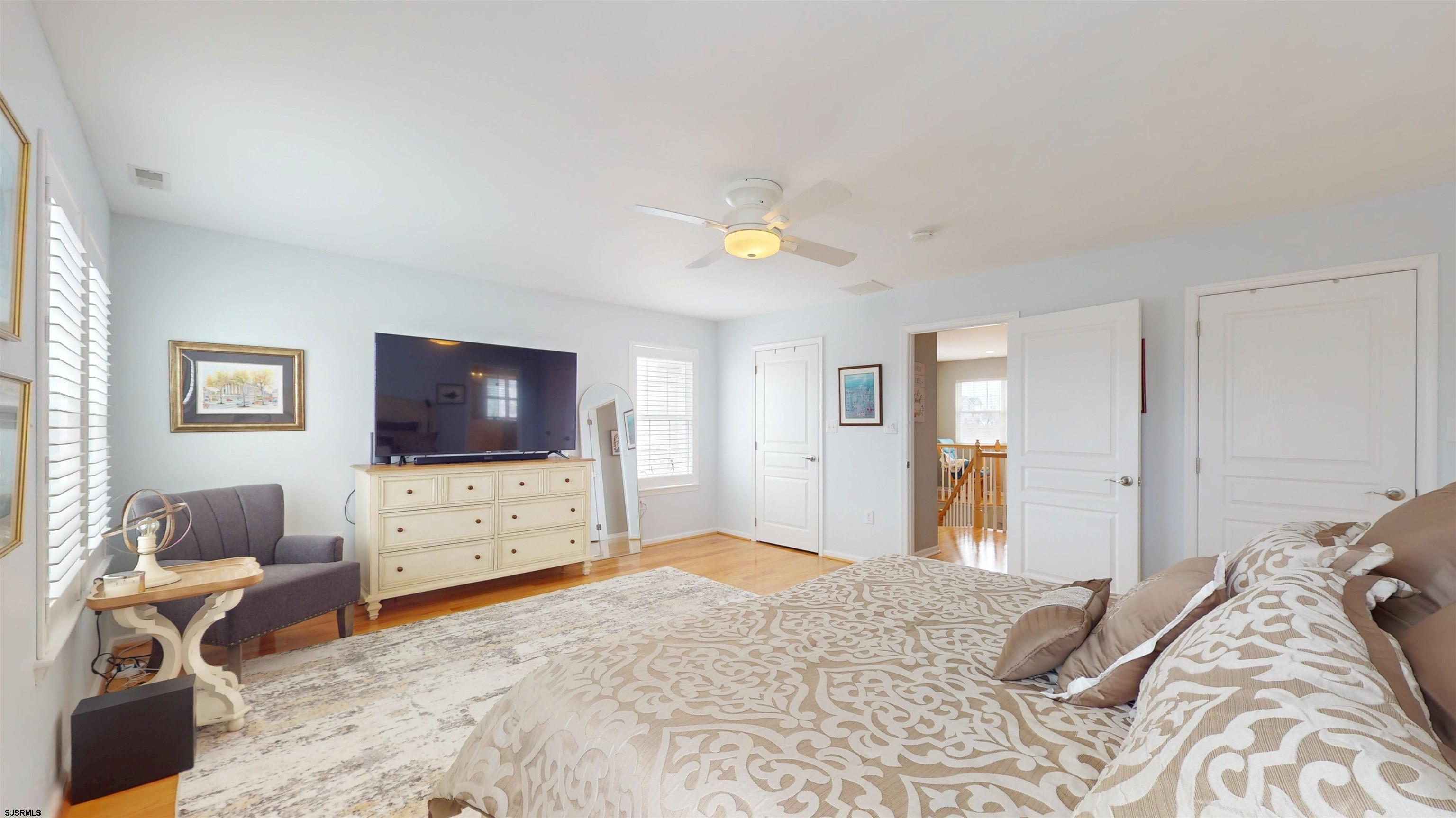 201 25th Street South Brigantine, NJ 08203 - Photo 32 of 60 a bedroom with a bed and a flat screen tv