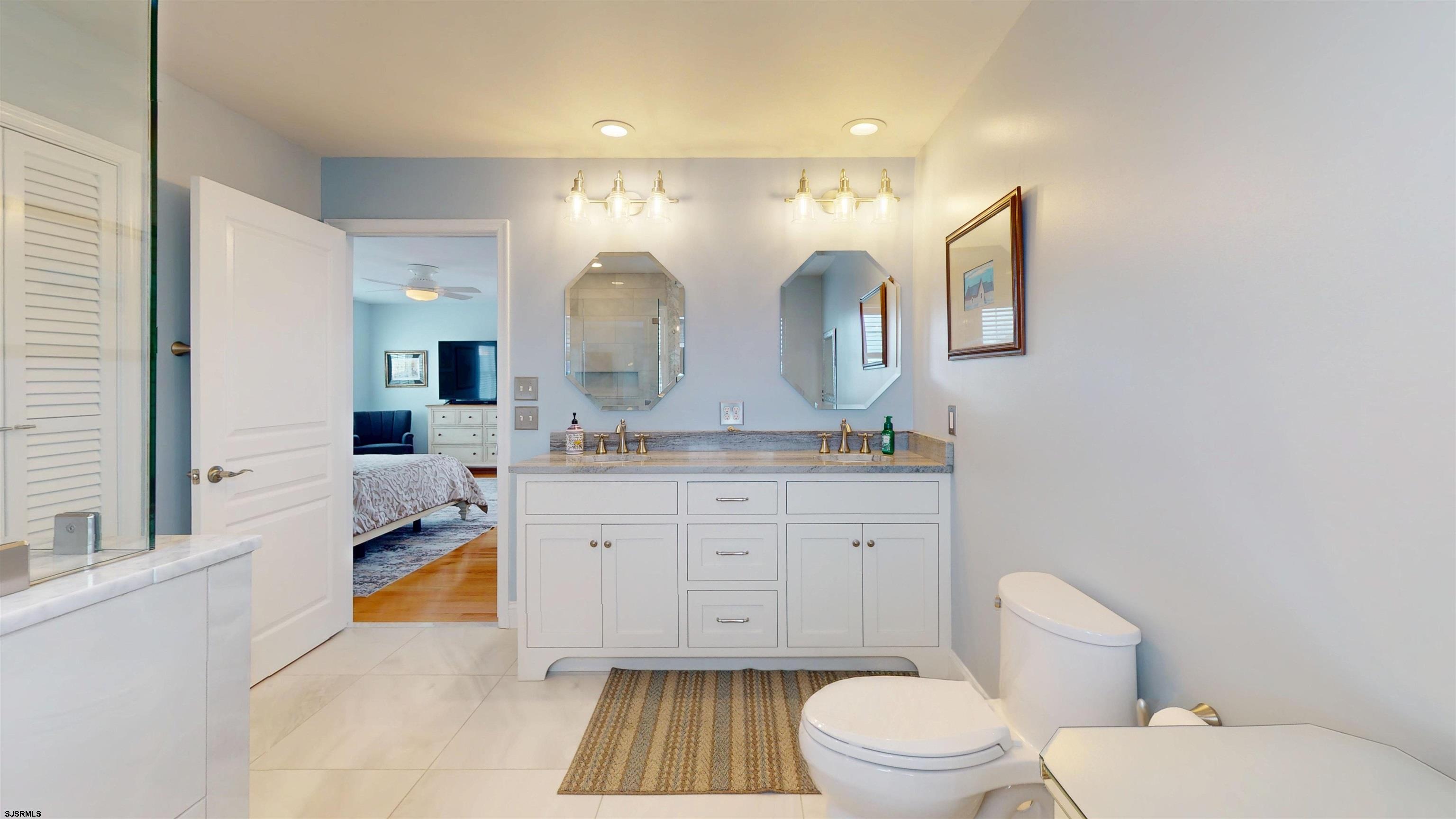 201 25th Street South Brigantine, NJ 08203 - Photo 35 of 60 a bathroom with a granite countertop sink mirror vanity and toilet
