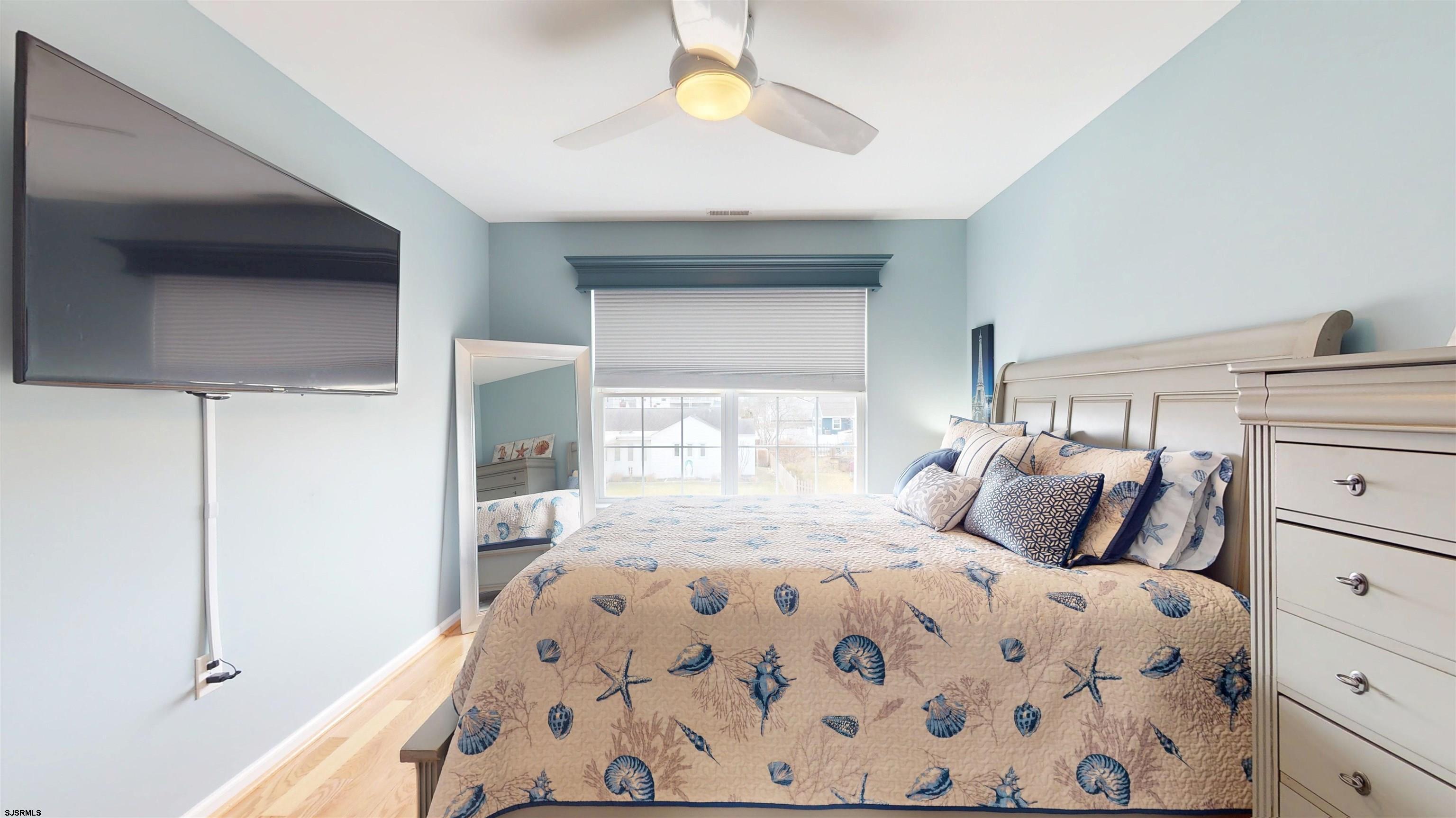 201 25th Street South Brigantine, NJ 08203 - Photo 42 of 60 a bedroom with a bed and a window