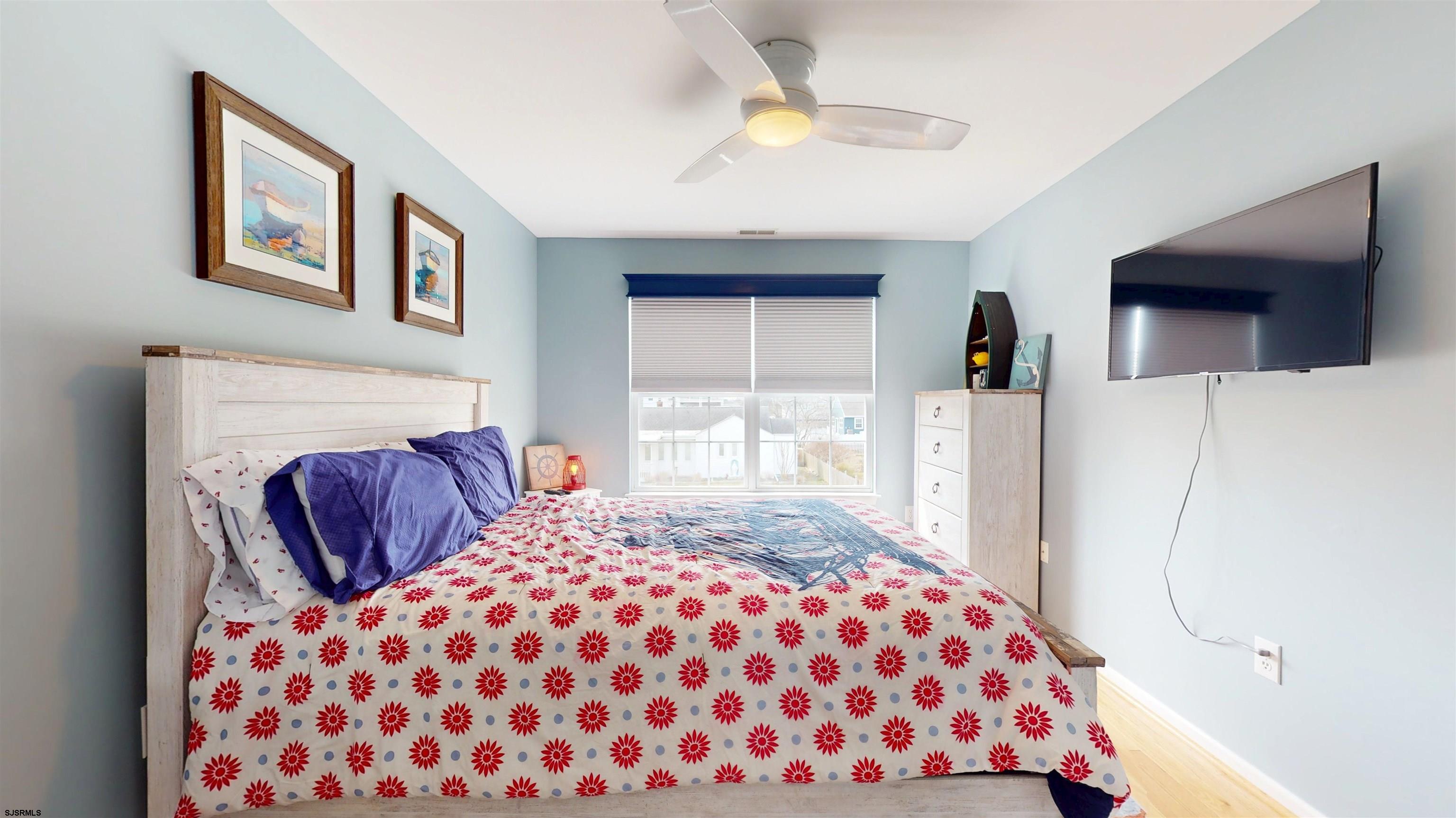 201 25th Street South Brigantine, NJ 08203 - Photo 43 of 60 a bedroom with a bed and a television