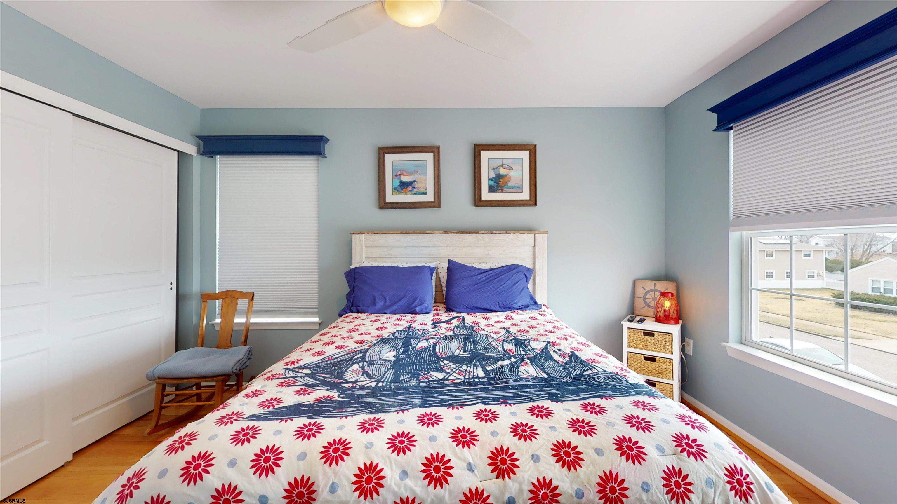 201 25th Street South Brigantine, NJ 08203 - Photo 45 of 60 a bedroom with a large bed and a window