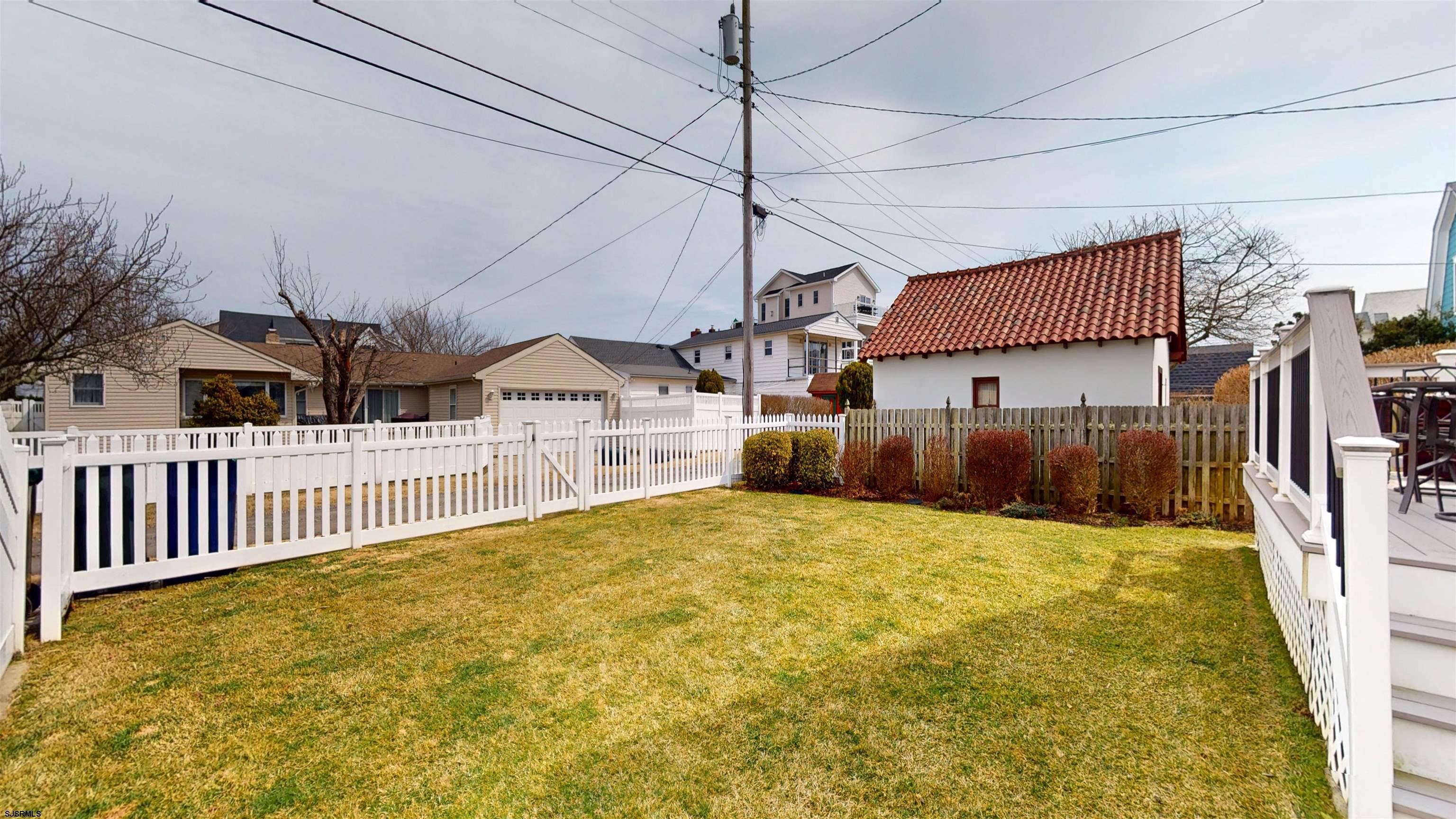 201 25th Street South Brigantine, NJ 08203 - Photo 52 of 60 a view of a house with a wooden fence