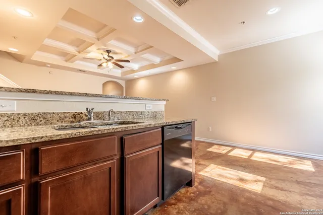 a kitchen with stainless steel appliances granite countertop a sink and a stove