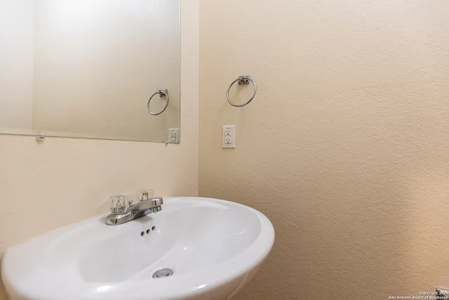 a bathroom with a sink and mirror
