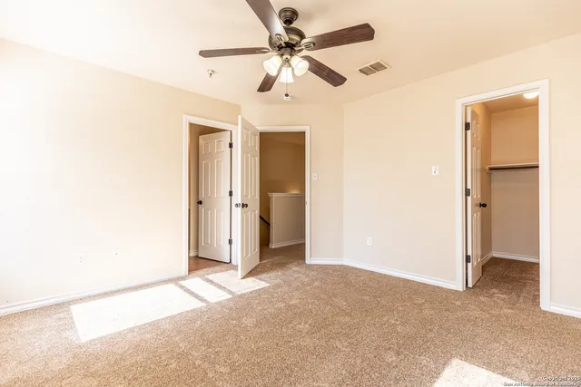a view of a livingroom with a ceiling fan and window