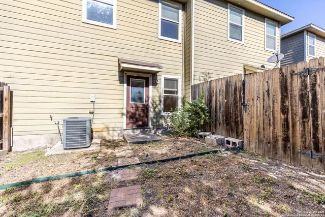 a view of a house with backyard and trees
