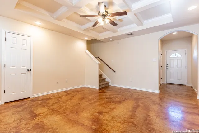 a view of an empty room with a ceiling fan