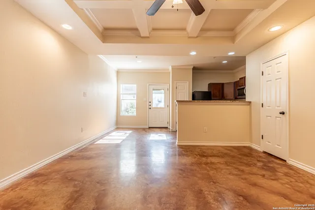 a view of a kitchen with a sink and a refrigerator