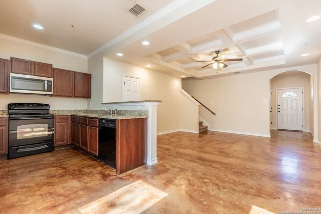 a kitchen with kitchen island a stove a sink and a refrigerator