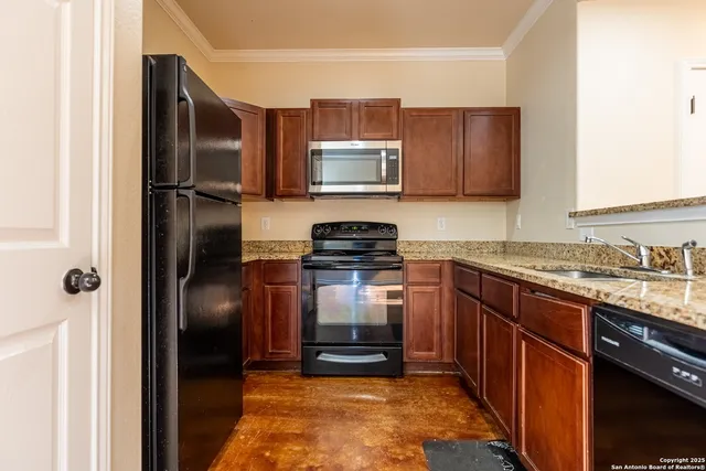 a kitchen with granite countertop stainless steel appliances and a refrigerator