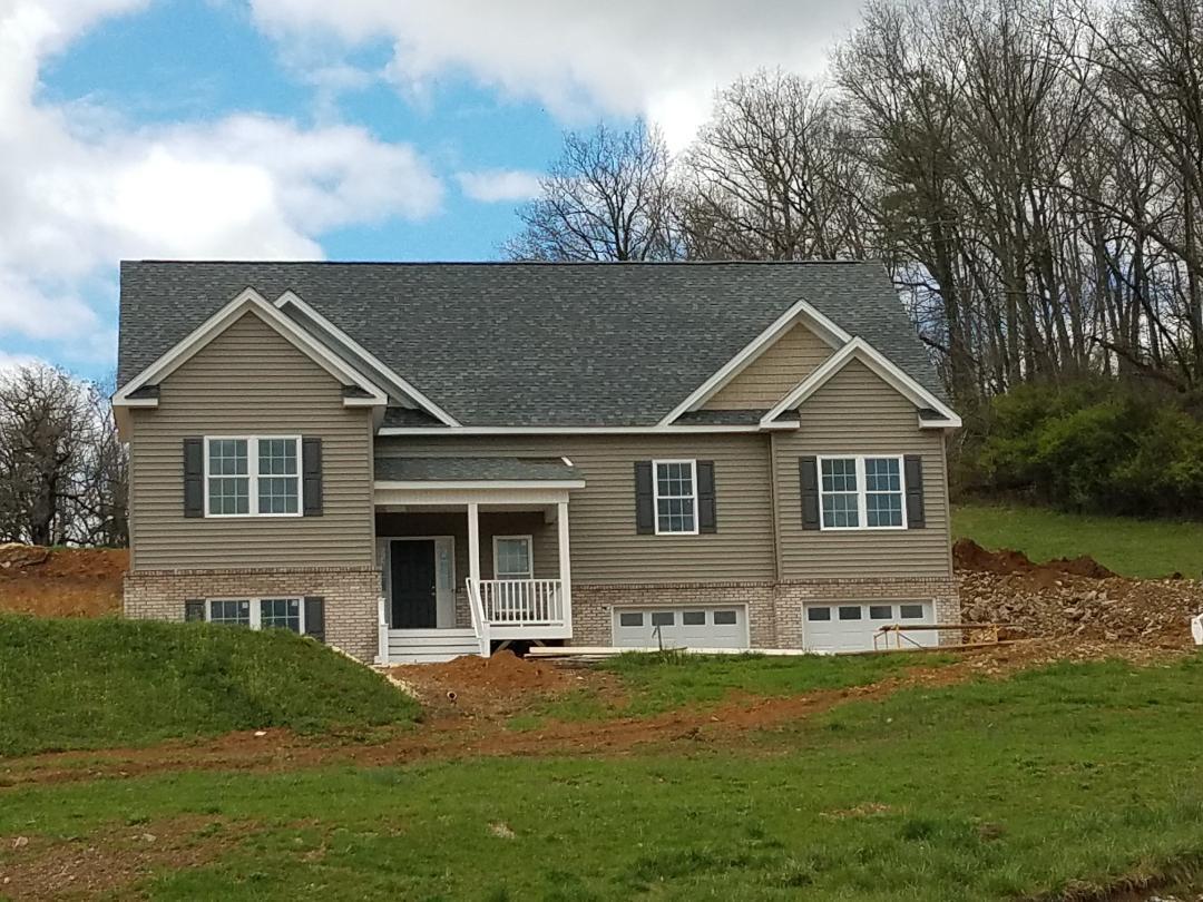 4461 Old Stage Road Radford, VA 24141 - Photo 2 of 21 a front view of a house with a garden
