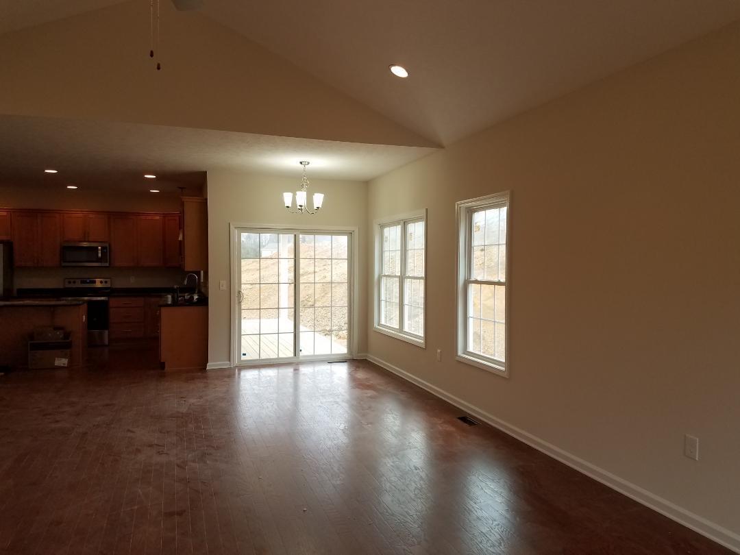 4461 Old Stage Road Radford, VA 24141 - Photo 4 of 21 a view of an empty room with wooden floor and a window