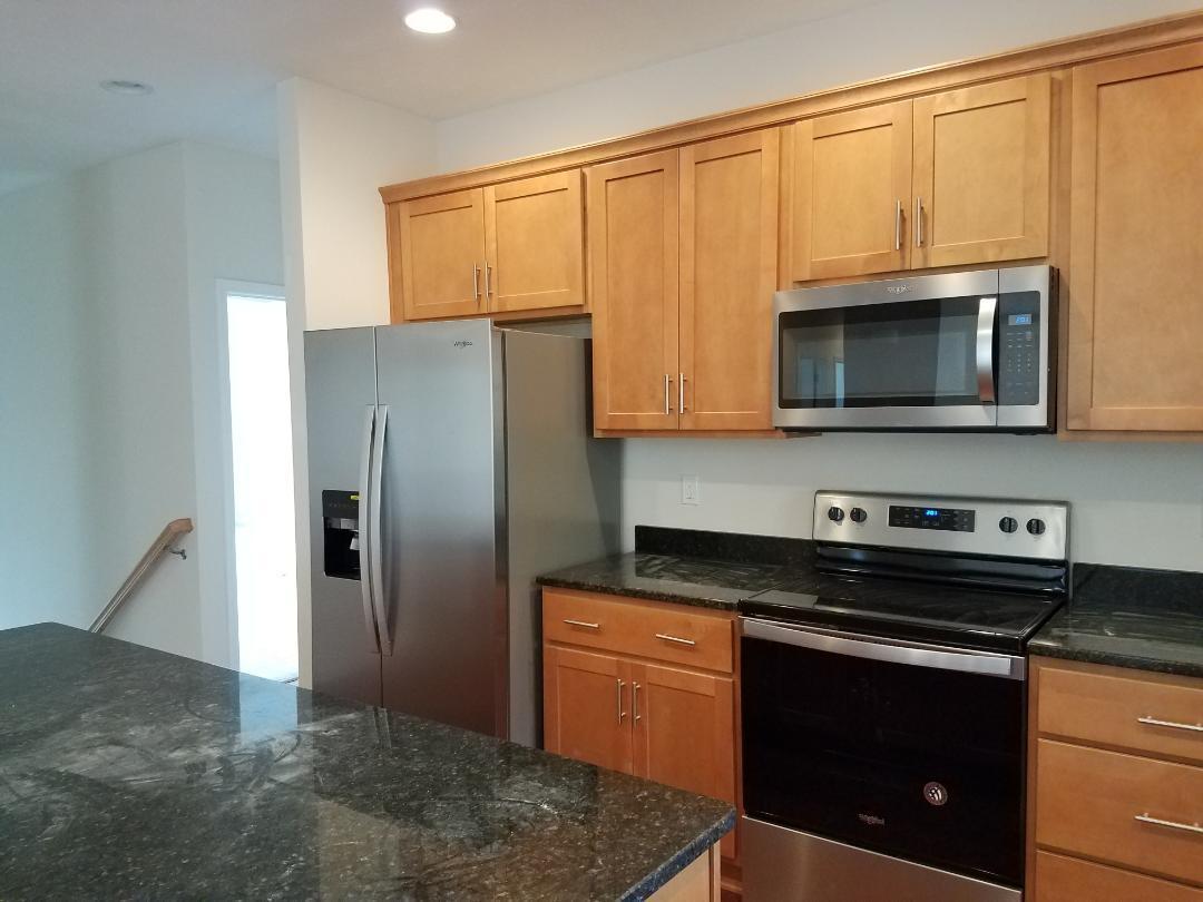 4461 Old Stage Road Radford, VA 24141 - Photo 8 of 21 a kitchen with stainless steel appliances granite countertop a stove a microwave and a refrigerator