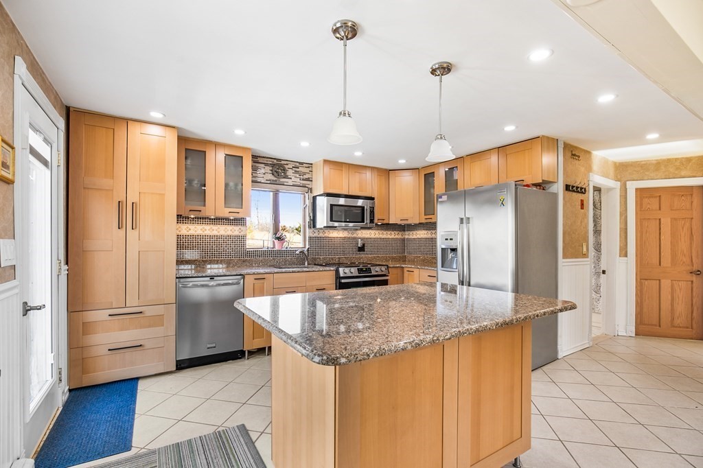 3 Harvey Road Chelmsford, MA 01824 - Photo 25 of 39 a kitchen with stainless steel appliances granite countertop a refrigerator a sink a stove and oven