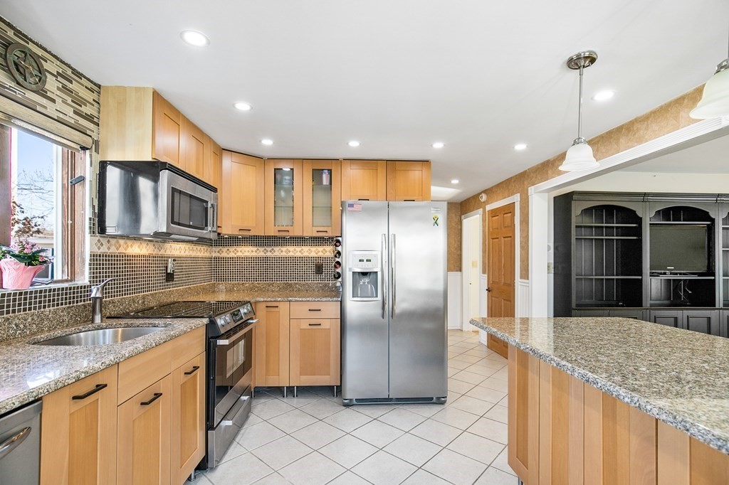 3 Harvey Road Chelmsford, MA 01824 - Photo 26 of 39 a kitchen with stainless steel appliances granite countertop a sink a stove and a refrigerator
