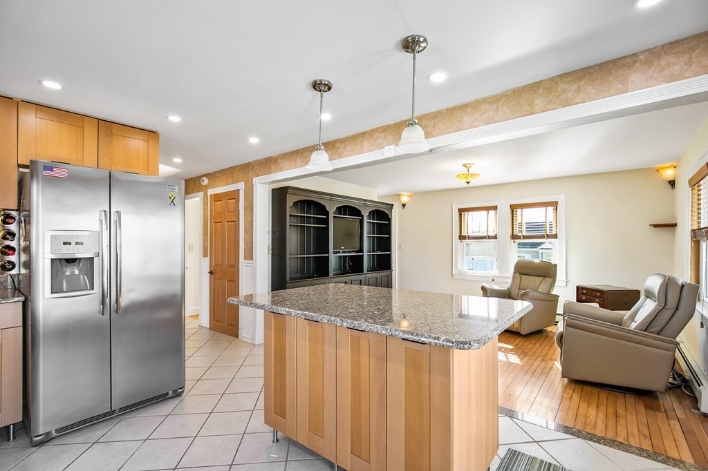 3 Harvey Road Chelmsford, MA 01824 - Photo 28 of 39 a large kitchen with kitchen island a large counter top space a sink stainless steel appliances and cabinets