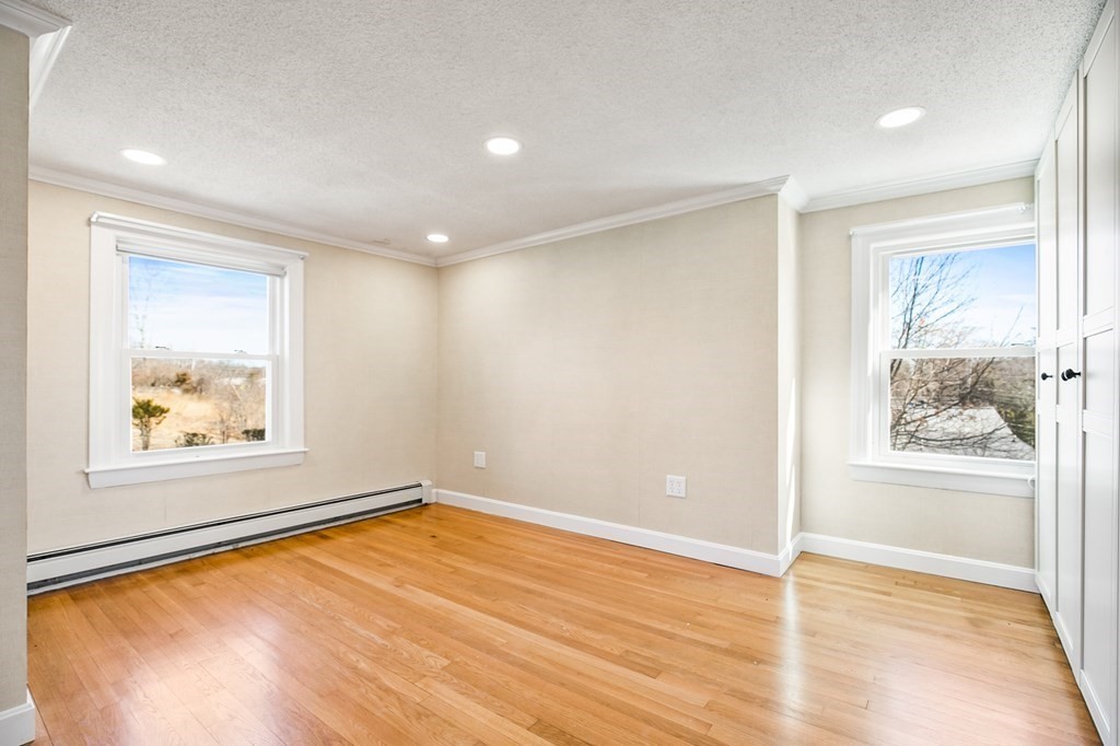 3 Harvey Road Chelmsford, MA 01824 - Photo 31 of 39 an empty room with a wooden floor and a window