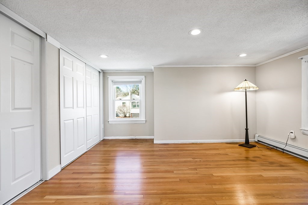 3 Harvey Road Chelmsford, MA 01824 - Photo 34 of 39 an empty room with wooden floor and windows