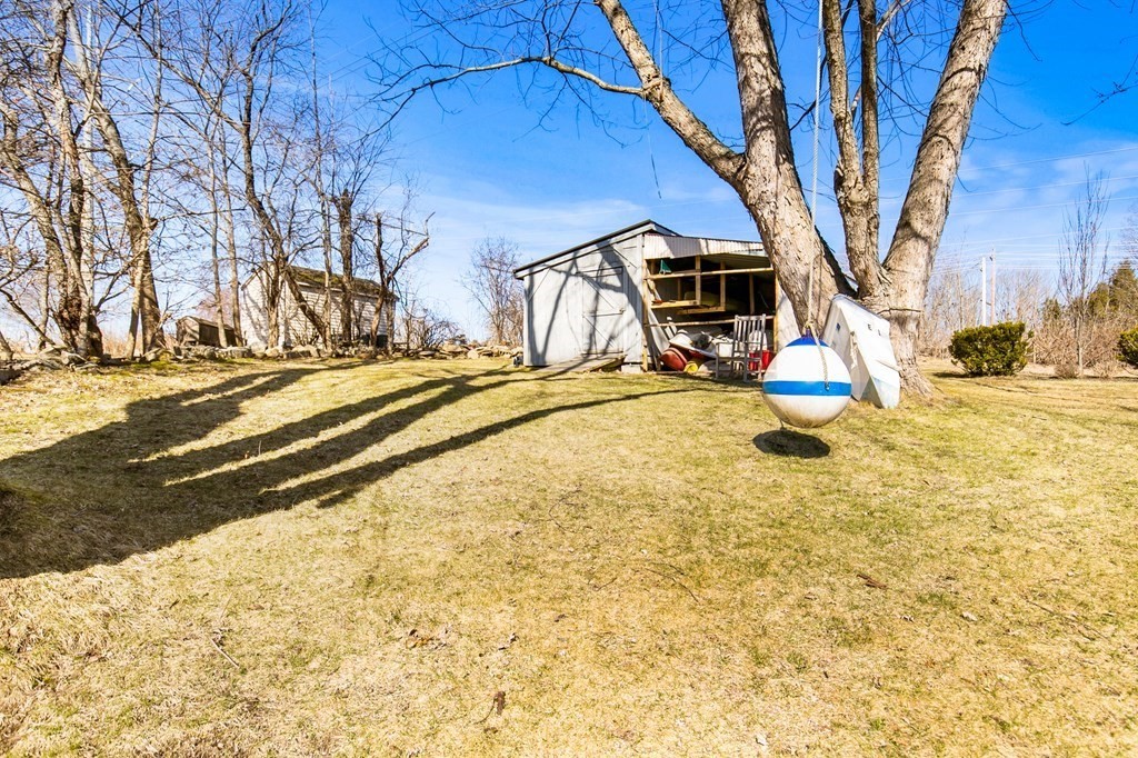 3 Harvey Road Chelmsford, MA 01824 - Photo 10 of 39 a view of a backyard with table and chairs and a large tree
