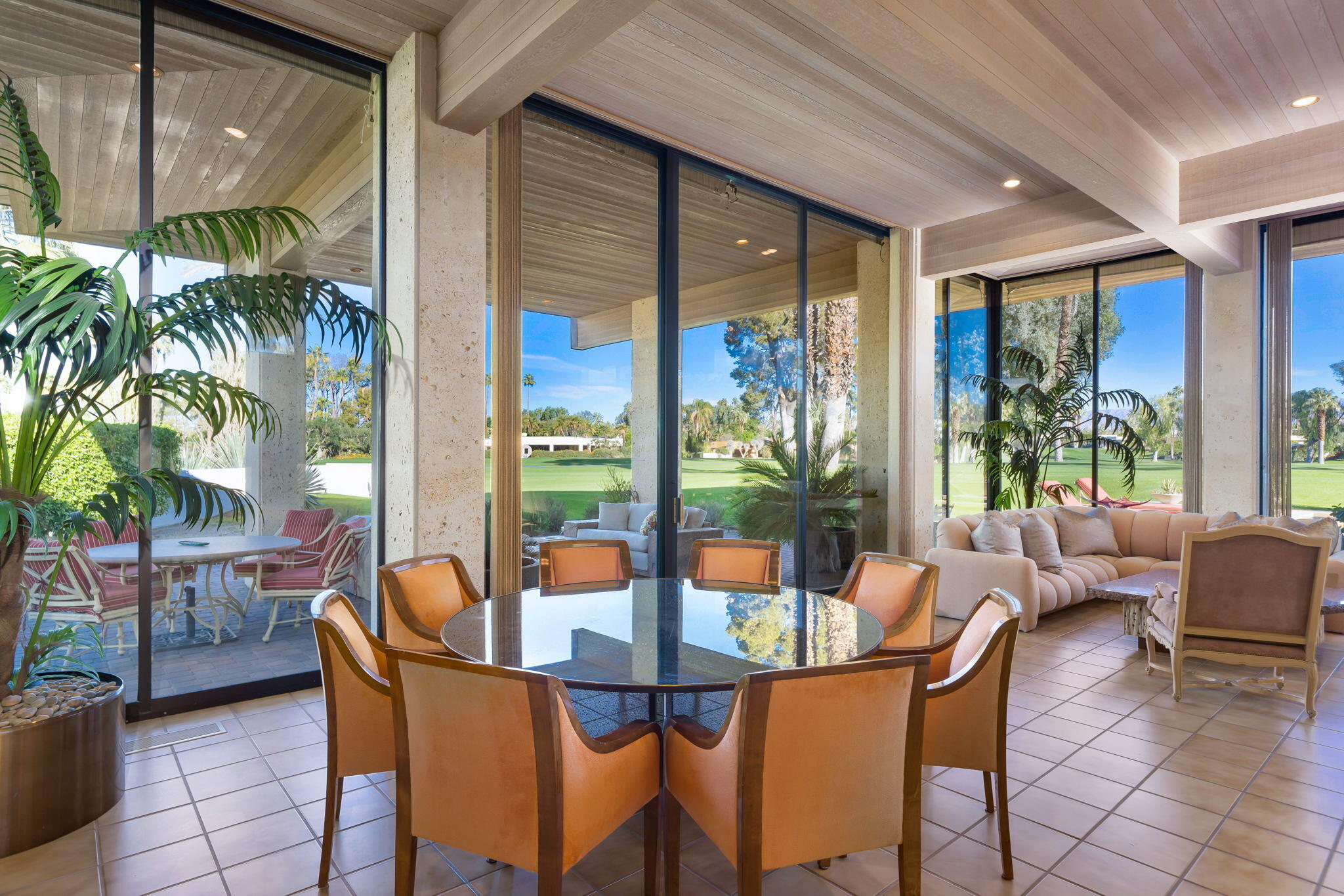 71094 La Paz Road Rancho Mirage, CA 92270 - Photo 7 of 38 a dining room with furniture a potted plant and a large window