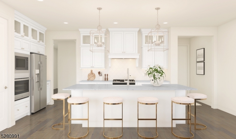 a white kitchen with cabinets and chairs