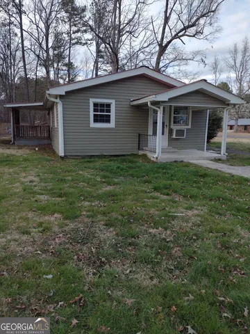 a backyard of a house with table and chairs