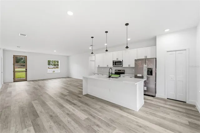 a bathroom with a granite countertop sink a large mirror and a bathtub