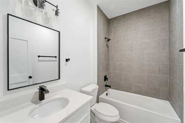 a bathroom with a sink a toilet and bathtub