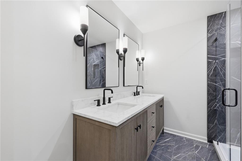 1121 Riverside Terrace Gainesville, GA 30501 - Photo 19 of 39 a bathroom with a double vanity sink and a mirror