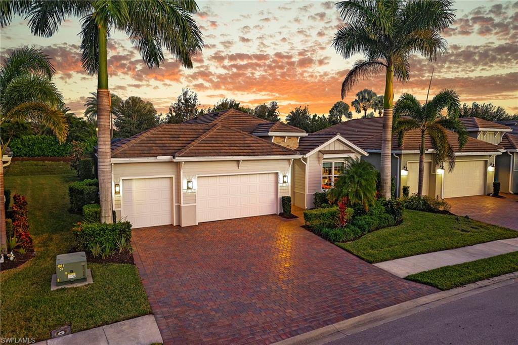 a front view of a house with a garden and yard