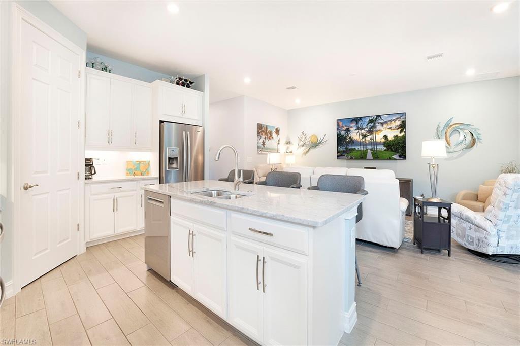 14534 Kelson Circle Naples, FL 34114 - Photo 12 of 50 a large white kitchen with cabinets