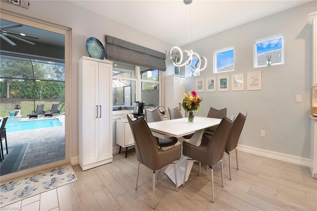 14534 Kelson Circle Naples, FL 34114 - Photo 14 of 50 a view of a dining room with furniture window and wooden floor
