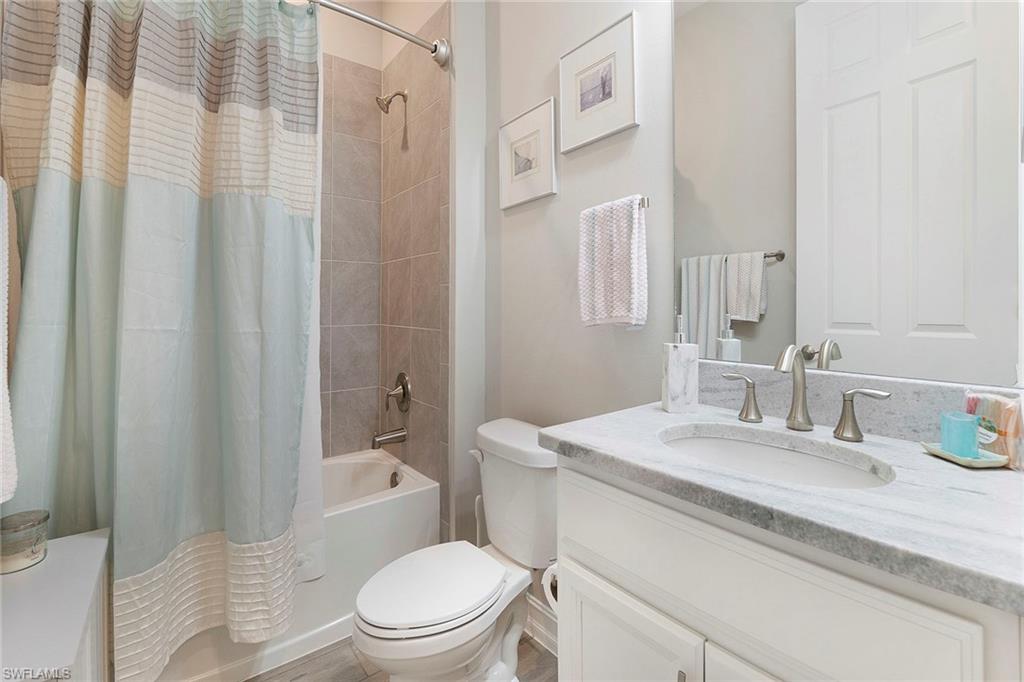 14534 Kelson Circle Naples, FL 34114 - Photo 23 of 50 a bathroom with a granite countertop sink toilet and shower