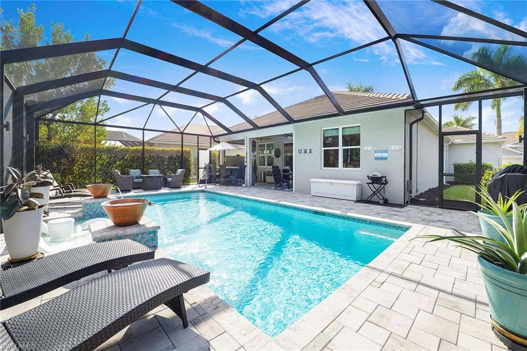 14534 Kelson Circle Naples, FL 34114 - Photo 30 of 50 a view of a patio with swimming pool table and chairs