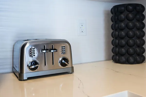 a kitchen with a refrigerator a sink and chairs
