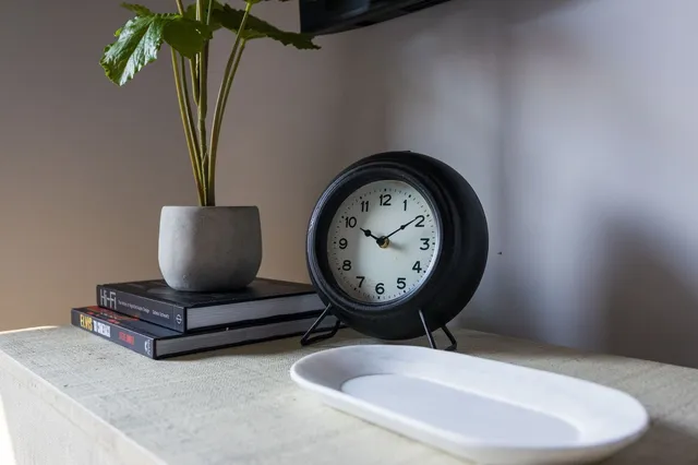 a bathroom with a granite countertop sink toilet a large mirror a glass door a shower and a mirror