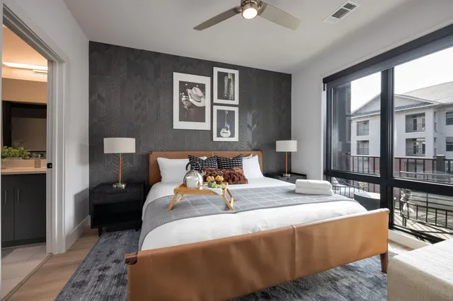 a bedroom with bed and wooden floor