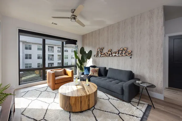 a living room with furniture and a potted plant