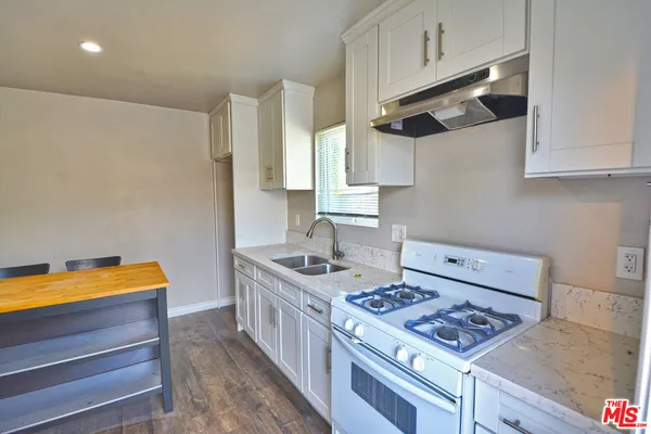 a kitchen with stainless steel appliances granite countertop a stove and a sink