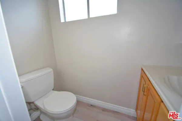 a white toilet sitting next to a small sink
