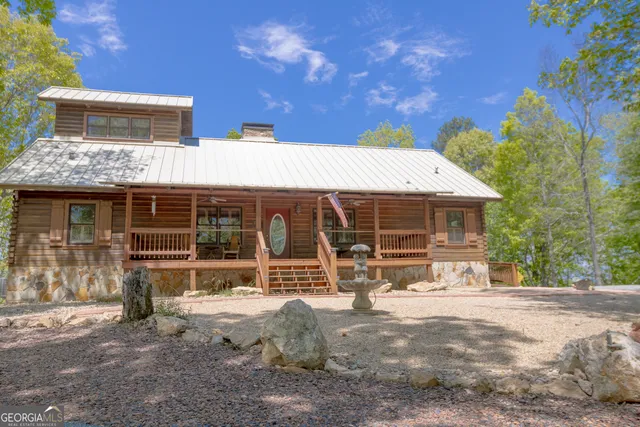 a kitchen with stainless steel appliances granite countertop a sink a stove and a wooden cabinets
