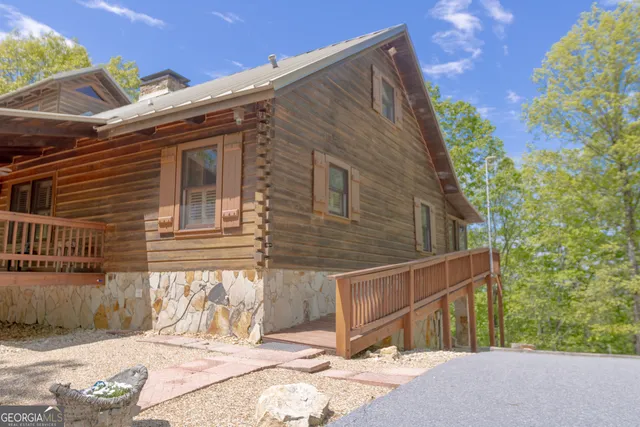 a kitchen with stainless steel appliances granite countertop a table chairs in it and wooden floors
