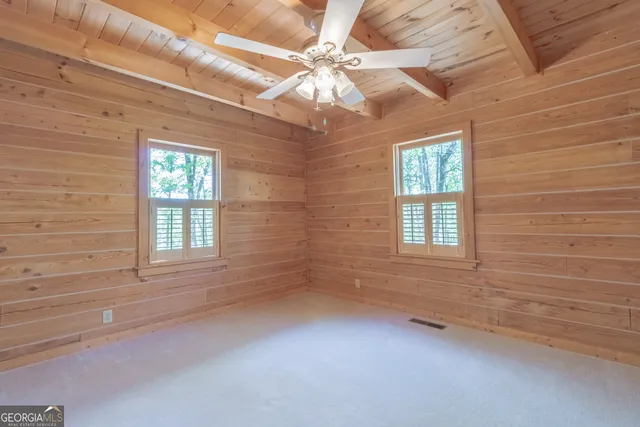 a view of a backyard with plants and a patio