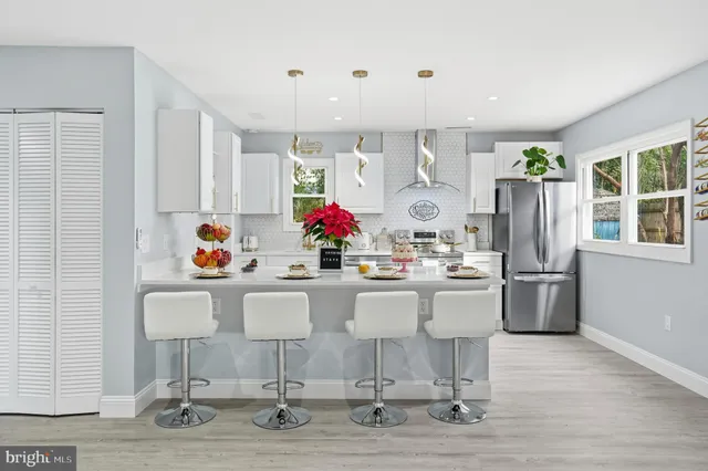 a kitchen with a sink refrigerator and window