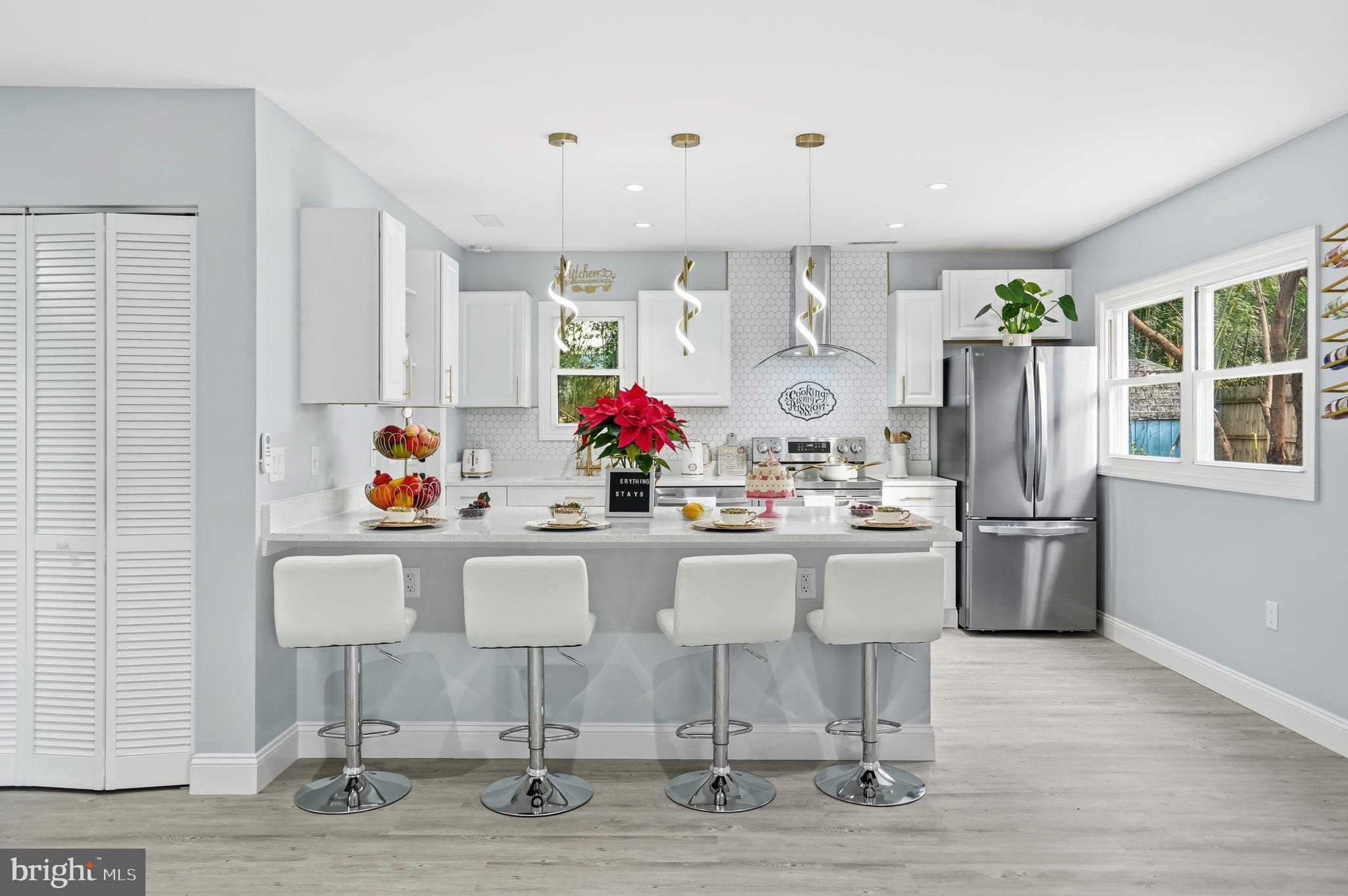 a kitchen with a sink refrigerator and window