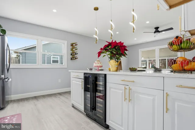 a kitchen with stainless steel appliances granite countertop a refrigerator a stove and a sink