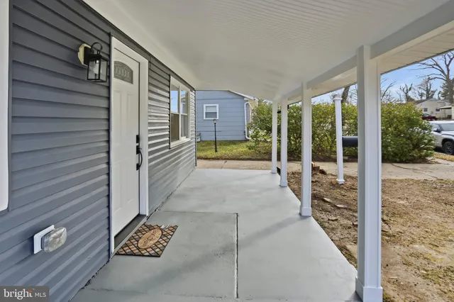 a view of a porch with wooden floor and fence