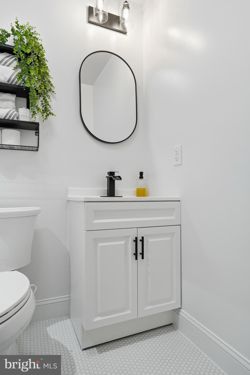 605 Sequoia Drive Edgewood, MD 21040 - Photo 20 of 28 a bathroom with a sink a toilet and a mirror