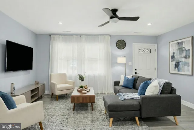 a living room with furniture and a flat screen tv