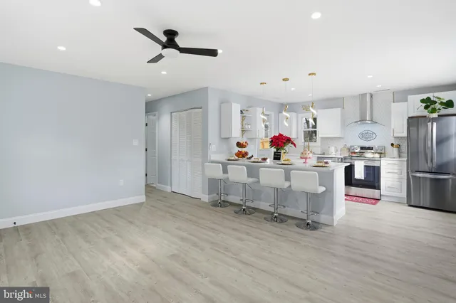 a kitchen with a sink refrigerator and window